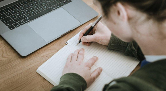 Person writing in a notebook